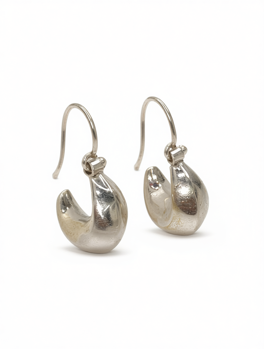 A pair of polished sterling silver teardrop hoop earrings, shown from the front against a white background